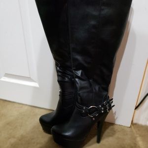 Tall boots with edgy buckle.